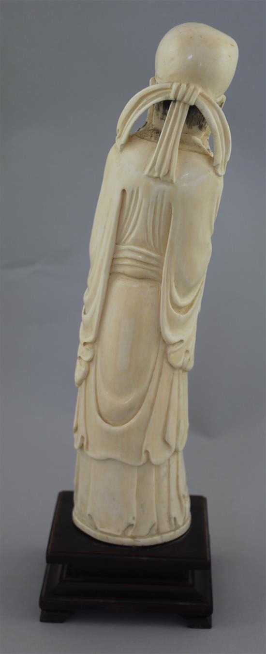 A large Chinese ivory figure of a scholar, early 20th century, 26.5cm, wood stand